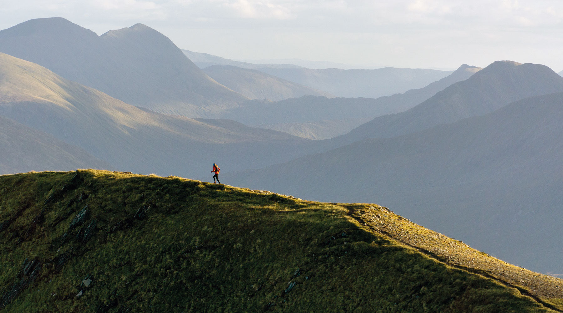 Suzy Devey on the South Glen Shiel Ridge, photo by by Finlay-Wild. Appears on the cover of Running Challenges by Keri Wallace.