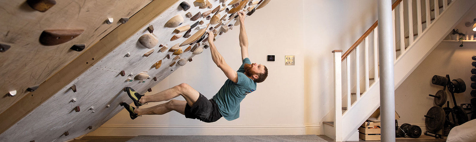 Ned Feehally climbing on his training boards during the production of his book Beastmaking (foreword by Shauna Coxsey), photo by Nick Brown